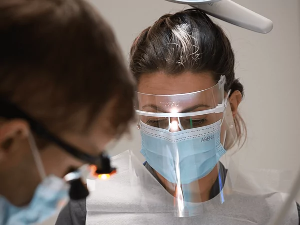 Tandhygienist utför puts och polering för att ta bort plack och missfärgningar.